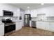 Modern kitchen with stainless appliances, subway tile backsplash, and white cabinets at 1455 Fieldcrest Cir, Rock Hill, SC 29732