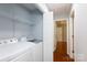 Functional laundry area featuring modern washer and dryer, with storage shelving at 1455 Fieldcrest Cir, Rock Hill, SC 29732