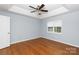 Bright bedroom featuring hardwood floors, ceiling fan, and window with blinds at 1455 Fieldcrest Cir, Rock Hill, SC 29732