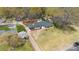 Aerial view of the property featuring a large lawn, mature trees, and a long driveway leading to the charming home at 1467 Alexander Rd, Rock Hill, SC 29732