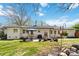 A spacious backyard featuring a white brick house, patio with furniture, and lush green lawn, perfect for outdoor living at 1467 Alexander Rd, Rock Hill, SC 29732