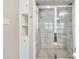 Elegant walk-in shower featuring glass enclosure and marble tiling with built-in shelving at 1467 Alexander Rd, Rock Hill, SC 29732
