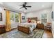 Bright bedroom featuring a bed, windows with curtains, and an area rug on hardwood floors at 1467 Alexander Rd, Rock Hill, SC 29732