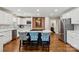 Bright, modern kitchen island with bar seating, stainless steel appliances, and white cabinets, creating a stylish space at 1467 Alexander Rd, Rock Hill, SC 29732