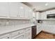 Bright kitchen with marble-patterned backsplash, stainless steel appliances, and abundant white cabinetry at 1467 Alexander Rd, Rock Hill, SC 29732