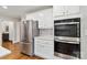 Modern kitchen with stainless steel appliances, white cabinets, and hardwood floors, offering both style and functionality at 1467 Alexander Rd, Rock Hill, SC 29732