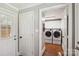 Clean laundry room with modern washer and dryer units, white cabinetry, and mosaic tiled floor at 1467 Alexander Rd, Rock Hill, SC 29732