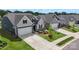 Aerial view showcasing new construction homes with landscaping and driveways on a sunny day at 167 White Apple Way, Statesville, NC 28625