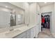 Bright bathroom with double sinks, quartz counters, tiled shower, and walk-in closet at 167 White Apple Way, Statesville, NC 28625