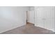 Carpeted bedroom with neutral walls, a view to the hallway, and double closet at 167 White Apple Way, Statesville, NC 28625