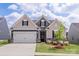 Charming, new construction home with stone accents, well-manicured lawn and a two-car garage at 167 White Apple Way, Statesville, NC 28625