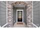 Close up of the front door with stone archway and a gray exterior at 167 White Apple Way, Statesville, NC 28625
