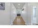 Hallway leading to the living room with hardwood floors and white walls at 167 White Apple Way, Statesville, NC 28625
