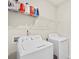 White laundry room with a full-sized washer, dryer, and wire shelving at 167 White Apple Way, Statesville, NC 28625