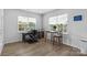 Bright home office with wood floors, two windows, and furniture, offering a functional workspace at 167 White Apple Way, Statesville, NC 28625