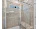 Modern shower stall featuring stylish tile, glass enclosure, and built-in bench at 167 White Apple Way, Statesville, NC 28625