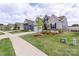A street view shows multiple homes with sidewalks and well-manicured lawns on a sunny day at 167 White Apple Way, Statesville, NC 28625