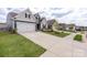 Street view of new construction homes with well-manicured lawns and sidewalks on a sunny day at 167 White Apple Way, Statesville, NC 28625