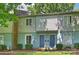 Charming townhome featuring blue doors, light siding, and well-maintained landscaping at 1931 Mereview Ct # 46, Charlotte, NC 28210