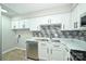 Kitchen featuring stainless steel appliances, stylish backsplash, and white cabinetry at 1931 Mereview Ct # 46, Charlotte, NC 28210