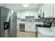 Well-lit kitchen with stainless steel appliances, light wood floors, and white cabinets at 1931 Mereview Ct # 46, Charlotte, NC 28210