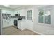 Modern kitchen featuring white cabinets, stainless steel appliances, and a mosaic backsplash at 1931 Mereview Ct # 46, Charlotte, NC 28210
