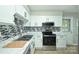 Bright kitchen boasts stainless steel appliances, stylish backsplash, and ample counter space at 1931 Mereview Ct # 46, Charlotte, NC 28210