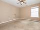 Empty bedroom with a ceiling fan and a window providing natural light at 208 Fielding St, Mount Holly, NC 28120