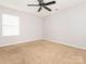 Empty bedroom with a window and a ceiling fan providing air circulation at 208 Fielding St, Mount Holly, NC 28120