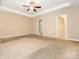 Large bedroom with neutral walls, ceiling fan, tray ceiling, and walk-in closet at 208 Fielding St, Mount Holly, NC 28120