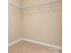 Walk-in closet with carpeted floor and metal shelving at 208 Fielding St, Mount Holly, NC 28120