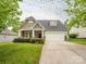 Charming home featuring a two-car garage, well-maintained landscaping, and a welcoming entrance at 208 Fielding St, Mount Holly, NC 28120