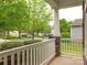 Charming front porch view with white railing and stone pillars, overlooking the street at 208 Fielding St, Mount Holly, NC 28120