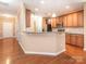 Bright kitchen features wooden cabinets, granite countertops, and modern appliances at 208 Fielding St, Mount Holly, NC 28120