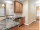 Kitchen view with granite counters, stainless steel appliances, sink, and wooden cabinets at 208 Fielding St, Mount Holly, NC 28120