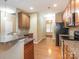 Modern kitchen features granite countertops, wooden cabinets, and stainless steel appliances at 208 Fielding St, Mount Holly, NC 28120