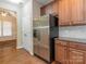 Kitchen with stainless steel refrigerator, wooden cabinets, and hardwood floors at 208 Fielding St, Mount Holly, NC 28120