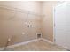 Functional laundry room features tile flooring, a utility sink, and ample space for storage at 208 Fielding St, Mount Holly, NC 28120