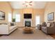 Comfortable living room featuring a fireplace, a large TV, and stylish decor at 208 Fielding St, Mount Holly, NC 28120