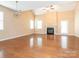 Spacious living room with hardwood floors, a cozy fireplace, and abundant natural light at 208 Fielding St, Mount Holly, NC 28120