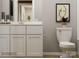 Bright bathroom featuring white cabinetry, countertop and toilet at 2107 Columbidae Ln, Gastonia, NC 28052