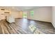 Open-concept living room with hardwood floors, recessed lighting, and sliding glass door at 2107 Columbidae Ln, Gastonia, NC 28052