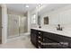 Bathroom featuring a dual sink vanity, and glass shower, tiled walls, and modern fixtures at 2309 Bulwarks Ct # 4P, Albemarle, NC 28001
