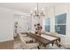 Well-lit dining area featuring a modern chandelier, large windows, and comfortable seating for six at 2309 Bulwarks Ct # 4P, Albemarle, NC 28001