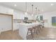 Modern eat-in kitchen with white cabinets, stainless steel appliances, and a large island with seating at 2309 Bulwarks Ct # 4P, Albemarle, NC 28001