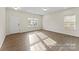 Living room features hardwood floors, a front door, and natural light from windows at 2309 Bulwarks Ct # 4P, Albemarle, NC 28001