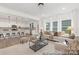 Open-concept living room connecting to kitchen, featuring hardwood floors and ample natural light at 2309 Bulwarks Ct # 4P, Albemarle, NC 28001