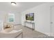 Relaxing upstairs loft space featuring neutral tones, plush carpet, and plenty of light at 2309 Bulwarks Ct # 4P, Albemarle, NC 28001