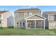 View of the back of a two-story home with a screened-in porch and a well-maintained lawn at 2309 Bulwarks Ct # 4P, Albemarle, NC 28001