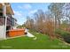 Lush backyard featuring a hot tub, manicured lawn, and surrounding trees and greenery at 2322 Morrison Rd, York, SC 29745